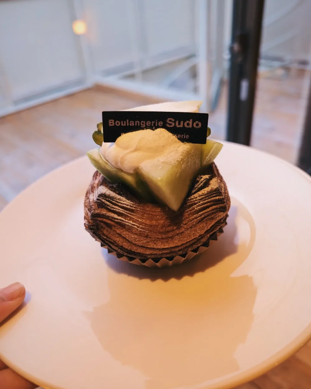 A picture of a melon danish on a plate.